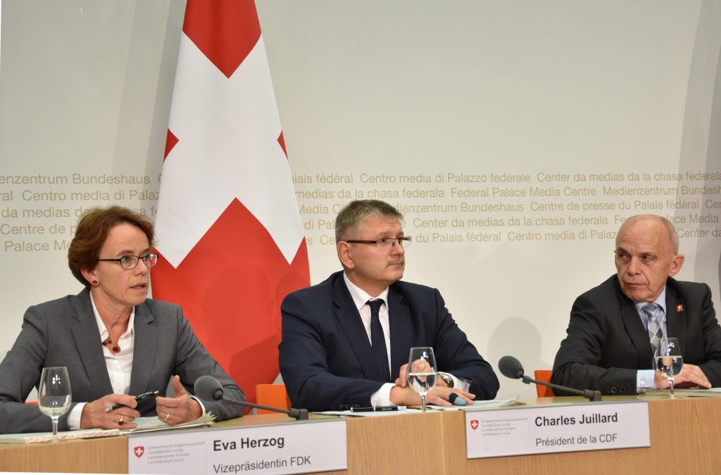 M. Charles Juillard, president of the Swiss Conference of Finance Directors of the Cantons, CDF, and Frau Eva Herzog (SP), a left-wing socialist politician from Basel-City.